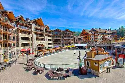 a resort with a pool and chairs and buildings at Northstar Getaway in Truckee