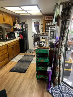 a kitchen with a refrigerator and a table in it at Casa Pura Vida in Modesto