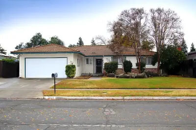 a white house with a white garage at Entire Magill House by RiverPark in Fresno