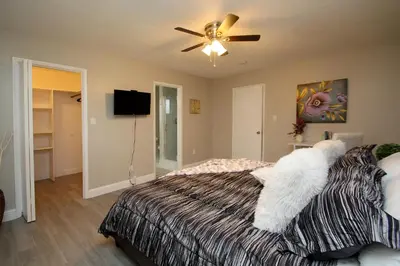 a bedroom with a bed and a ceiling fan at Entire Magill House by RiverPark in Fresno