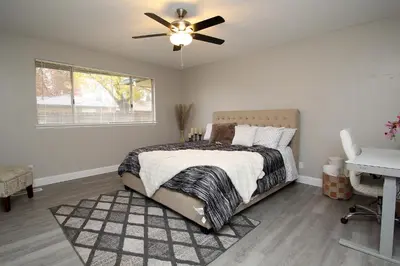 a bedroom with a bed and a ceiling fan at Entire Magill House by RiverPark in Fresno