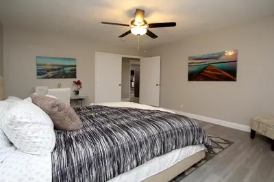 a bedroom with a bed and a ceiling fan at Entire Magill House by RiverPark in Fresno