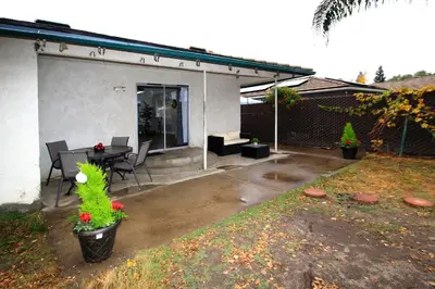 a patio of a house with a table and chairs at Entire Magill House by RiverPark in Fresno