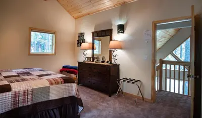 a bedroom with a bed and a dresser and a mirror at 11N Margaret in North Wawona