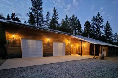 a house with two garage doors and lights at Jordan Creek Ranch in Groveland