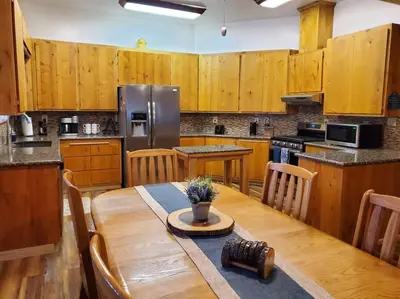 a kitchen with a wooden table and a refrigerator at Jordan Creek Ranch in Groveland