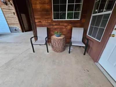 two chairs and a table in front of a house at Jordan Creek Ranch in Groveland