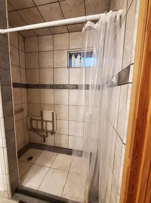 a shower with a shower curtain in a bathroom at Jordan Creek Ranch in Groveland