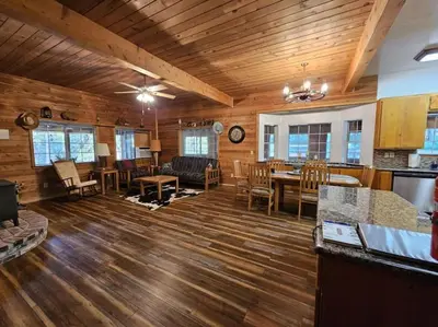 a large living room with wooden floors and a dining room at Jordan Creek Ranch in Groveland