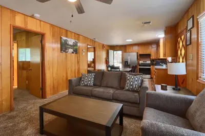 a living room with a couch and a table at 17C The Redwoods Cabin in North Wawona