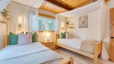 a bedroom with two beds and a window at Peaceful Tahoe Retreat by AvantStay Cozy Modern Cabin • Sauna Hot Tub Fireplace • Near Lake in Carnelian Bay