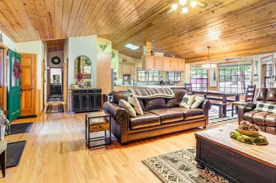 a living room with a couch and a table at Fire Pit, Gazebo and Grill Family Cabin in Arnold! in Arnold