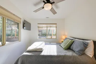 a bedroom with a bed and a ceiling fan at Ski, Hike and Fish Mtn-View Gem with Deck in Tuolumne in Tuolumne