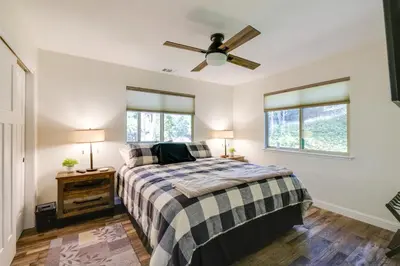 a bedroom with a bed and a ceiling fan at Ski, Hike and Fish Mtn-View Gem with Deck in Tuolumne in Tuolumne