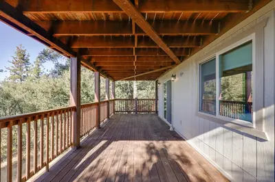 a porch of a home with a wooden deck at Ski, Hike and Fish Mtn-View Gem with Deck in Tuolumne in Tuolumne