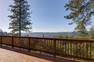 a wooden deck with a view of the mountains at Ski, Hike and Fish Mtn-View Gem with Deck in Tuolumne in Tuolumne