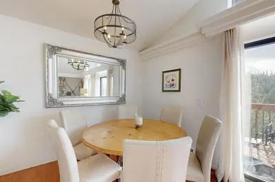 a dining room with a table and chairs and a mirror at Bear-foot Retreat in Incline Village