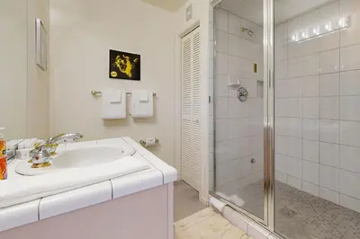 a white bathroom with a sink and a shower at Bear-foot Retreat in Incline Village