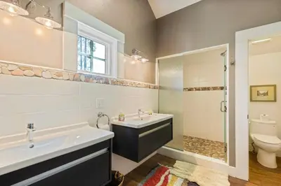 a bathroom with a sink and a tub and a toilet at Belleview Lakefront by Tahoe Getaways - Hot Tub, Pier, Buoy and Guest House in Homewood