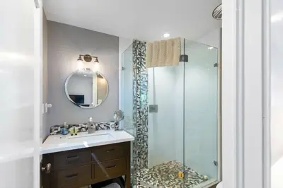 a bathroom with a sink and a shower at Belleview Lakefront by Tahoe Getaways - Hot Tub, Pier, Buoy and Guest House in Homewood
