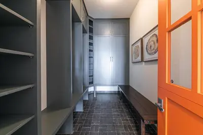 a hallway with an orange door and some shelves at Spellbound Lakefront Lodge by Tahoe Getaways - 5 BR w Hot Tub, Buoy & Beach access in Kings Beach
