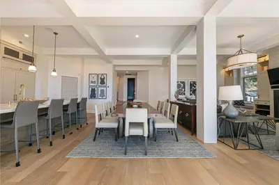 a dining room and kitchen with a table and chairs at Spellbound Lakefront Lodge by Tahoe Getaways - 5 BR w Hot Tub, Buoy & Beach access in Kings Beach