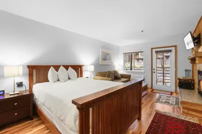 a bedroom with a large bed and a couch at Kirkwood Retreat - 2 Bedroom Condo condo in Kirkwood