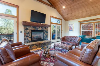 a living room with leather furniture and a fireplace at Luxury Lodge-Hot Tub-BBQ-Sleeps 18 in Oakhurst