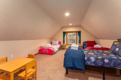a living room with a couch and a table at Luxury Lodge-Hot Tub-BBQ-Sleeps 18 in Oakhurst