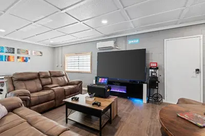 a living room with leather furniture and a flat screen tv at 4000 SF, 20 Acre Gated Luxe Estate, Game Room, Pano View, Pool, Spa in Coarsegold