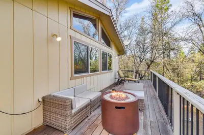 a screened in porch with a fire pit on a deck at Deck and Fire Pit Pine Mountain Lake Getaway! in Groveland