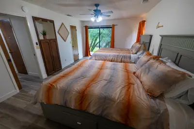 a bedroom with a bed with a comforter on it at Sierra Vista Near Yosemite #Majestic Views# Tesla EV in Oakhurst