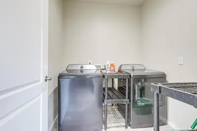 a laundry room with two washing machines and a counter at On-Site Winery Rural Plymouth Getaway! in Plymouth