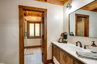 a bathroom with a sink and a mirror at Bear Lodge Waterfront Cabin with Level 2 EV Charger in Sutter Creek