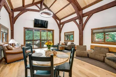 a living room with a table and chairs at Bear Lodge Waterfront Cabin with Level 2 EV Charger in Sutter Creek