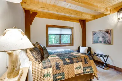 a bedroom with a bed and a window at Bear Lodge Waterfront Cabin with Level 2 EV Charger in Sutter Creek