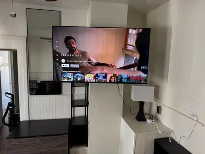 a flat screen tv on a wall in a living room at Midtown Hideaway 1 BR Nest in Reno