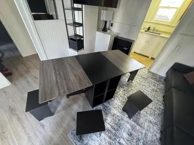 a wooden table in the middle of a living room at Midtown Hideaway 1 BR Nest in Reno