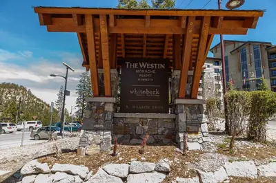 a sign in front of a building with a sign at Updated Pet Friendly Monache Studio with Views! in Mammoth Lakes