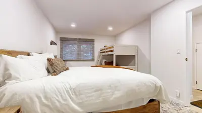 a white bedroom with a large bed and a window at Lakeview Villas #06 condo in Mammoth Lakes