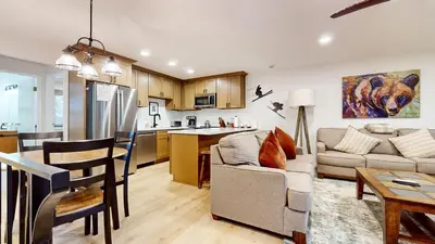 a living room and kitchen with a couch and a table at Lakeview Villas #06 condo in Mammoth Lakes