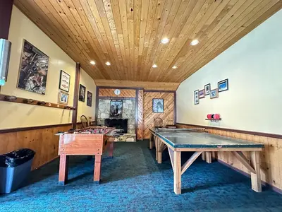 a room with two ping pong tables and a wooden ceiling at Lakeview Villas #06 condo in Mammoth Lakes