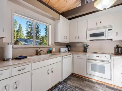 a kitchen with white cabinets and a window at Awesome Home Above the Lake - Dogs Welcome VH315 in Bear Valley