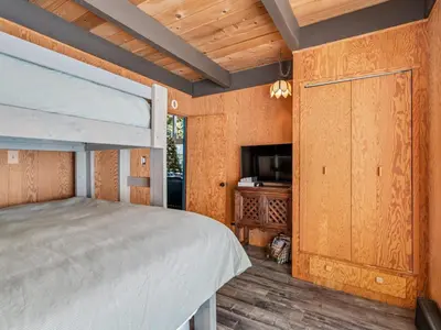 a bedroom with a bunk bed and a television at Awesome Home Above the Lake - Dogs Welcome VH315 in Bear Valley