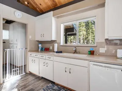 a kitchen with white cabinets and a window at Awesome Home Above the Lake - Dogs Welcome VH315 in Bear Valley