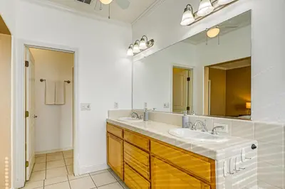 a bathroom with two sinks and a large mirror at 26 Mi to Fresno Pet-Friendly Home in Reedley! in Reedley