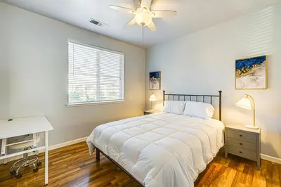 a bedroom with a bed and a desk and a window at 26 Mi to Fresno Pet-Friendly Home in Reedley! in Reedley
