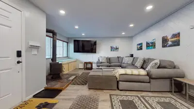 a living room with a couch and a flat screen tv at Sierra Manors #61 condo in Mammoth Lakes