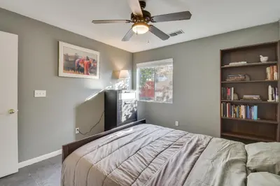 a bedroom with a bed and a ceiling fan at 4 Mi to San Joaquin River Peaceful Patterson Home in Patterson