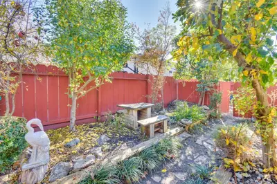 a garden with a bench and a fence at 4 Mi to San Joaquin River Peaceful Patterson Home in Patterson